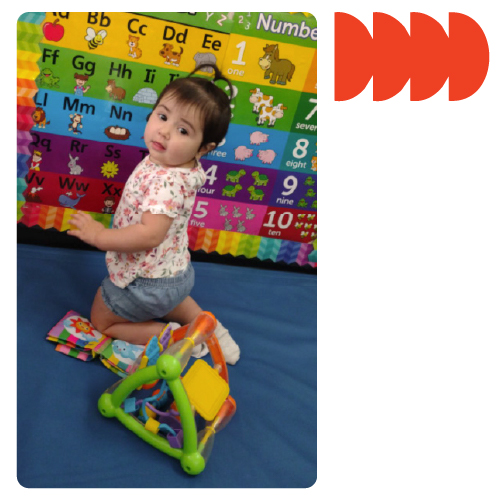 Baby playing in activity center at Learning Center Live Oak infant classroom