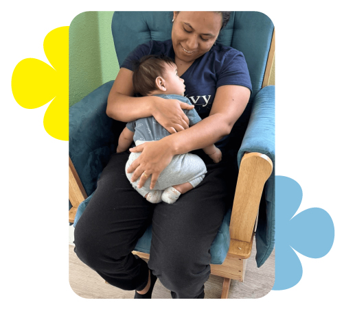 Caregiver holding baby with affection at Learning Center Live Oak daycare San Antonio