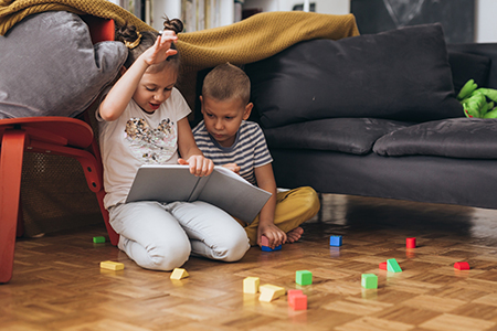 Children reading together at home supporting early literacy daycare Kerrville