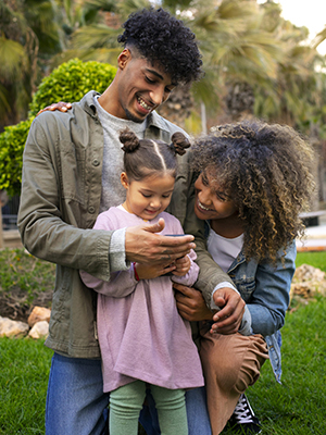 Parents and daughter sharing a moment together while reviewing information during a daycare tour.