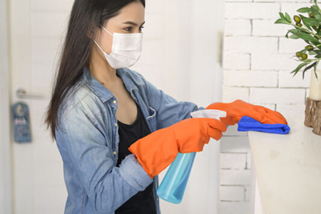 Staff cleaning and disinfecting surfaces while choosing a daycare center focused on safety like Live Oak Bright Beginnings Daycare and Preschool in San Antonio, Texas